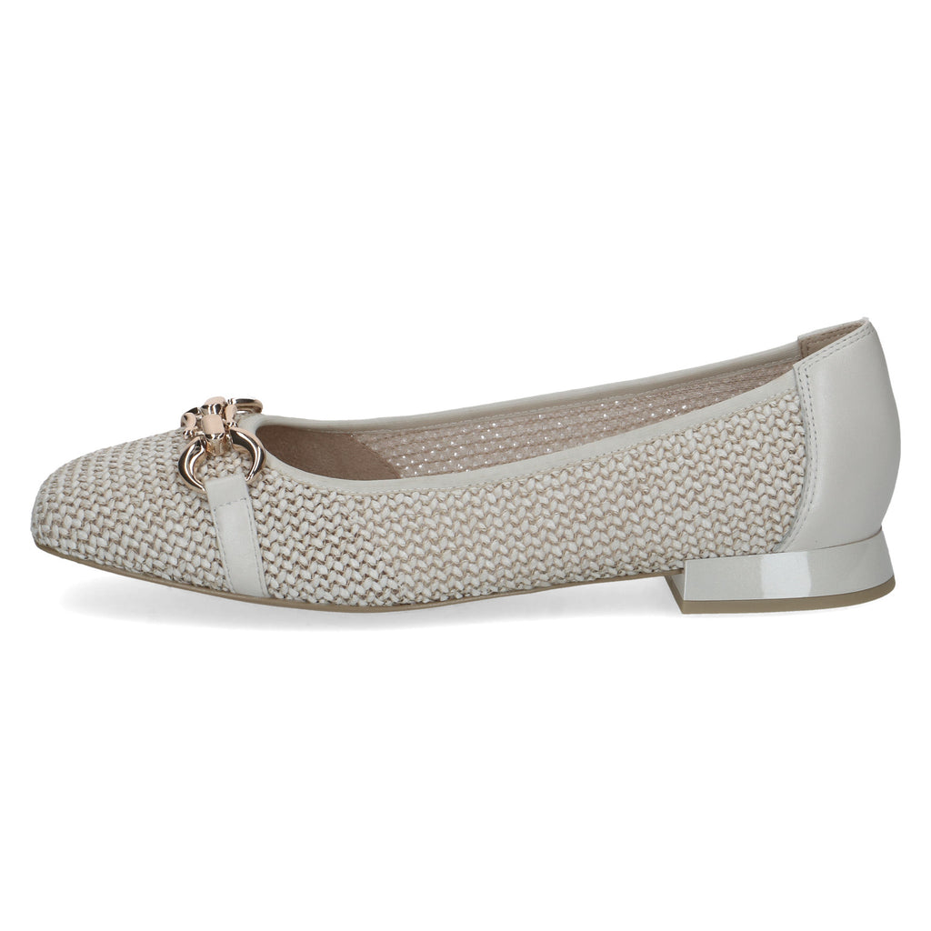 beige flat shoe with a decorative strap on a white background