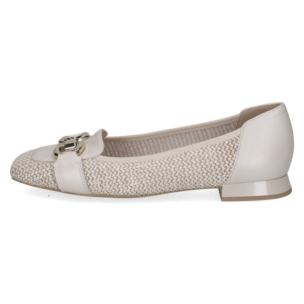 White flat shoe with textured strap on a white background