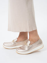 Load image into Gallery viewer, Gold loafers worn with beige pants on a light background
