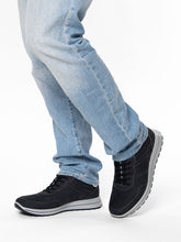 Load image into Gallery viewer, navy sneakers worn with light blue jeans on a white background

