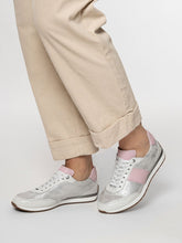 Load image into Gallery viewer, silver sneakers with pink accents worn with beige pants on a white background
