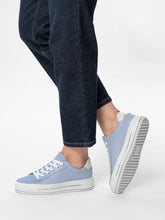 Load image into Gallery viewer, Light blue sneakers worn with dark jeans on a white background
