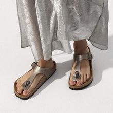 Load image into Gallery viewer, Person wearing metallic sandals with a plain background
