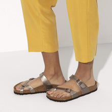 Load image into Gallery viewer, Person wearing metallic sandals and yellow pants on a white background
