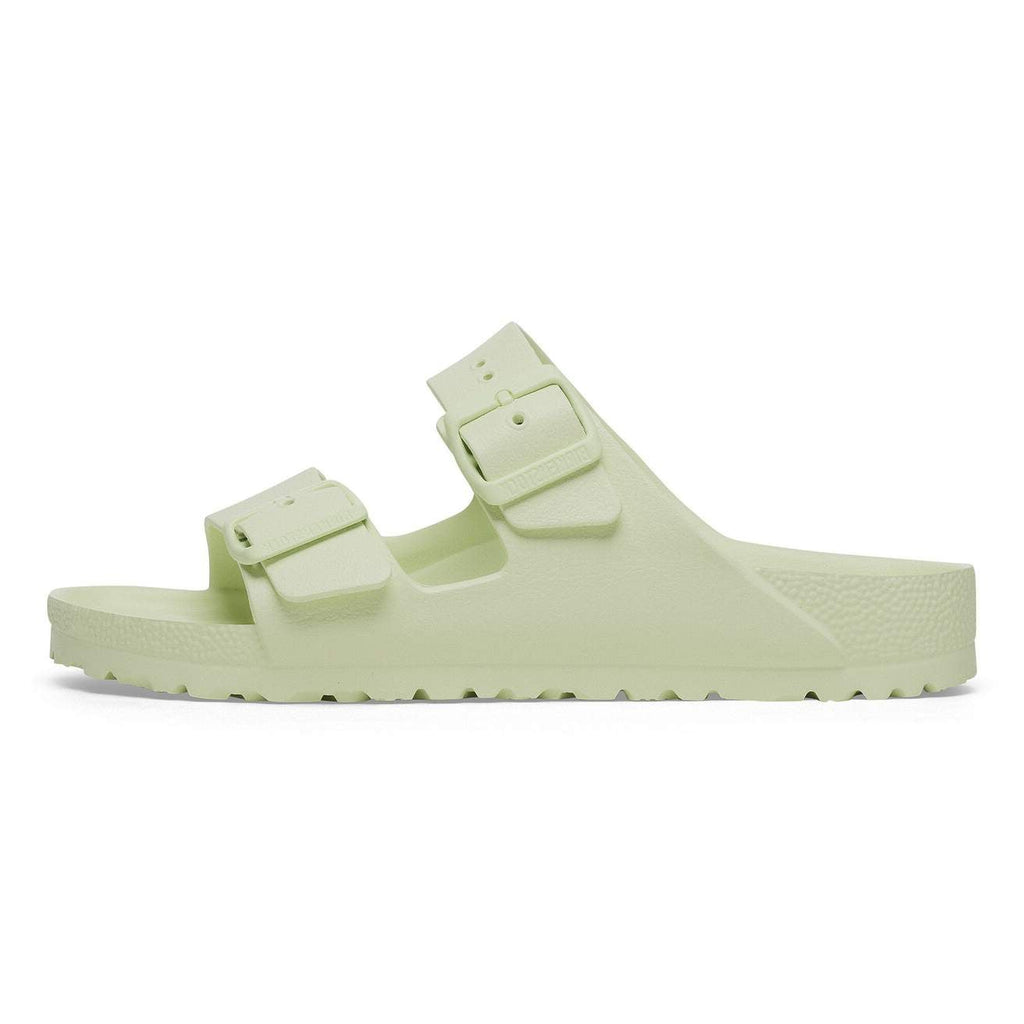 Light green sandal with double buckle on a white background