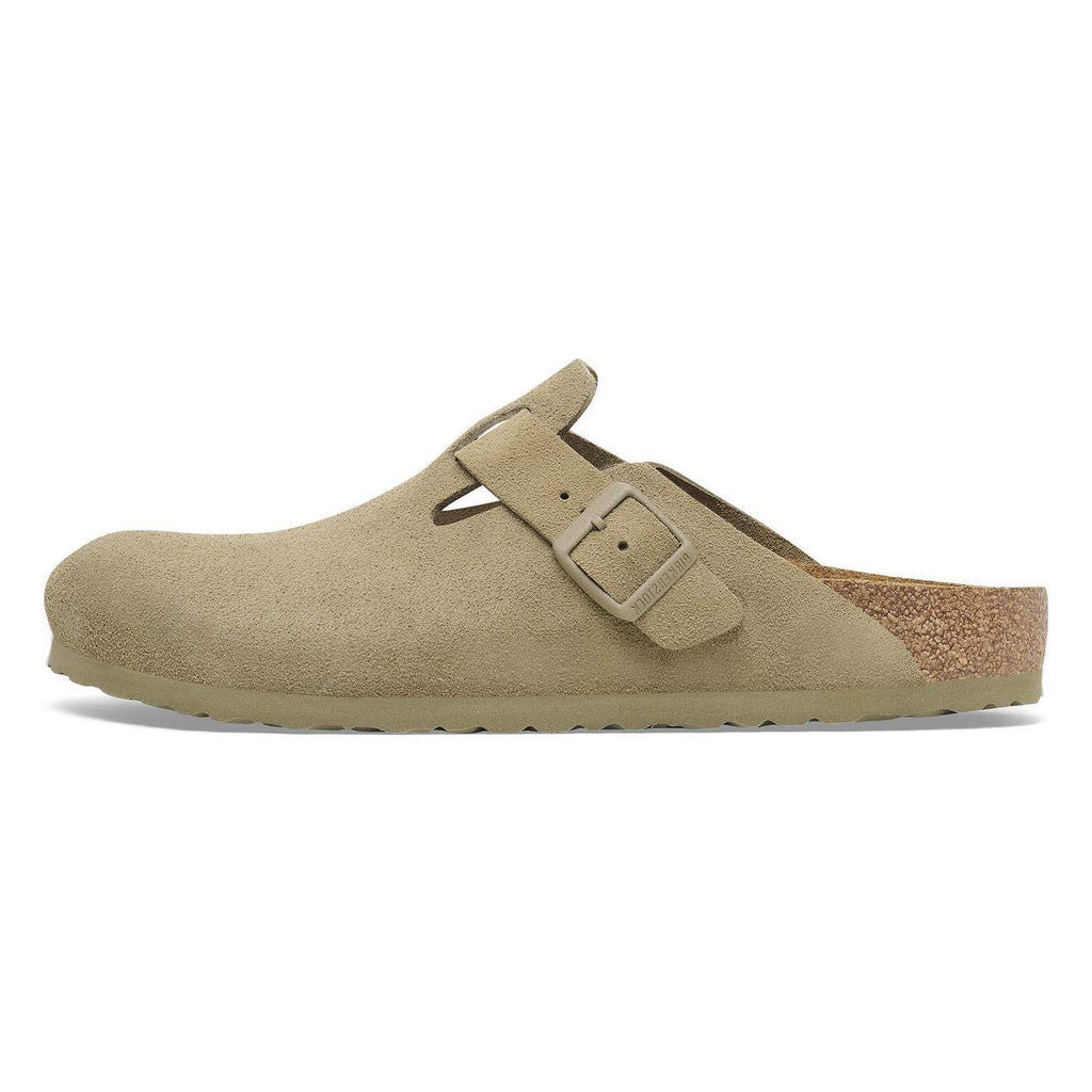 Beige clog shoe with a buckle on a white background