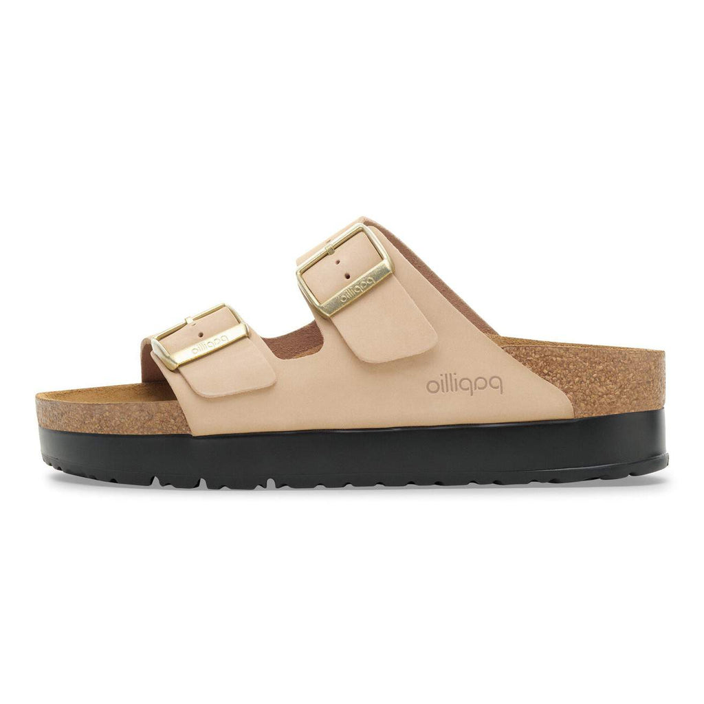 Beige sandal with gold buckles on a white background
