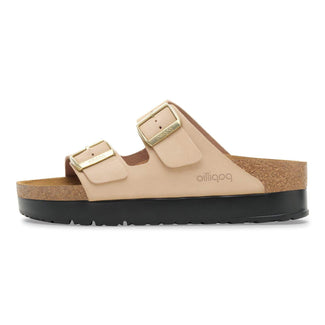 Beige sandal with gold buckles on a white background