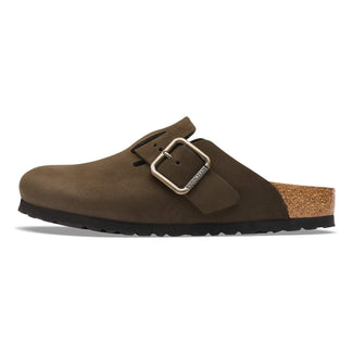 Brown suede clog shoe with a buckle on a white background