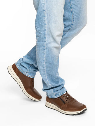 Brown sneaker with white sole on a white background