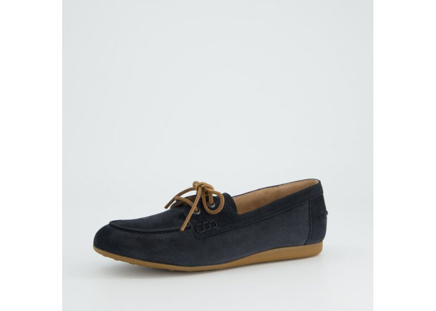 navy loafer shoe with brown sole on a light gray background