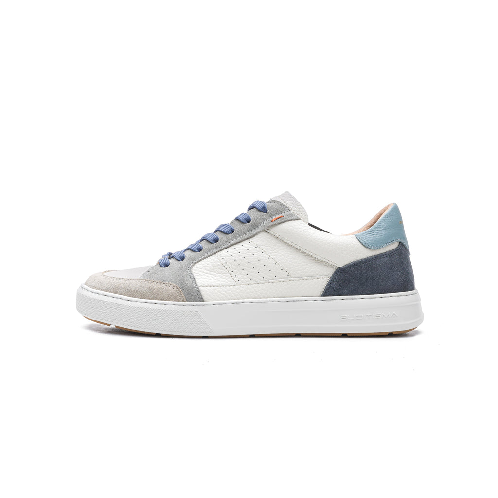 White sneaker with blue and gray accents on a white background