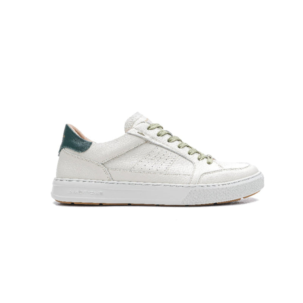 White sneaker with green accents on a white background