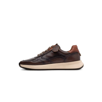 A dark brown leather sneaker with a tan heel tab, matching brown laces, and a thick beige midsole, shown in a side profile on a white background.