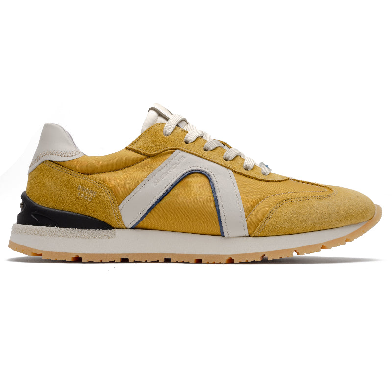 Yellow sneaker with white accents on a white background