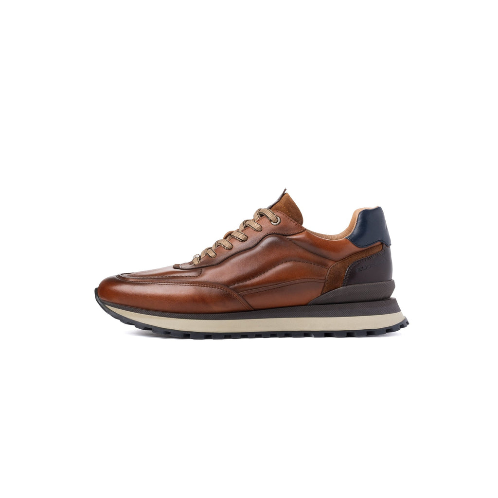 A brown leather low-top sneaker with a thick black and beige midsole, shown in a side profile on a white background.