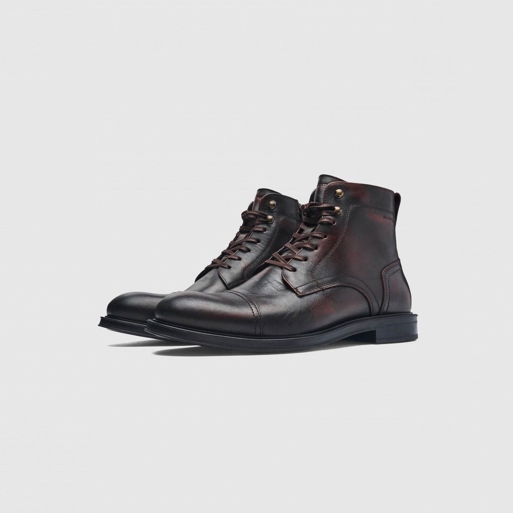 Pair of black leather Chelsea boots on a white background