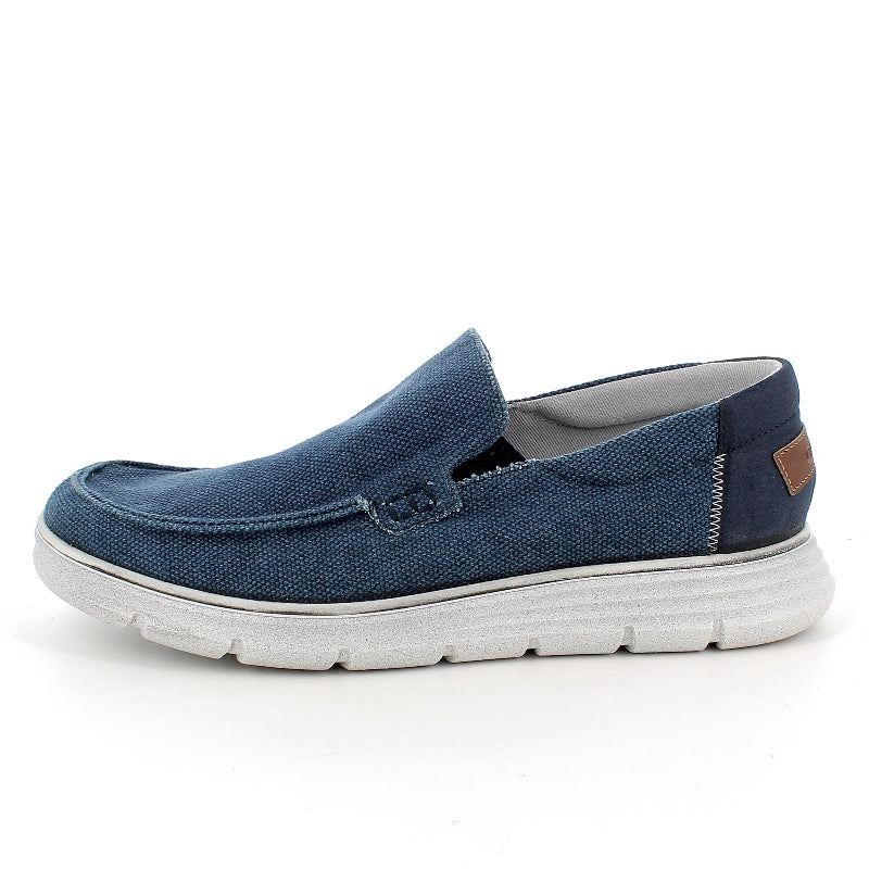 Blue slip-on shoe with white sole on a white background