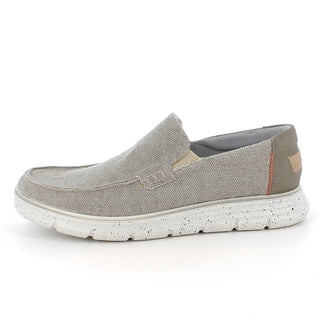 Green sneaker with a white sole on a light gray background