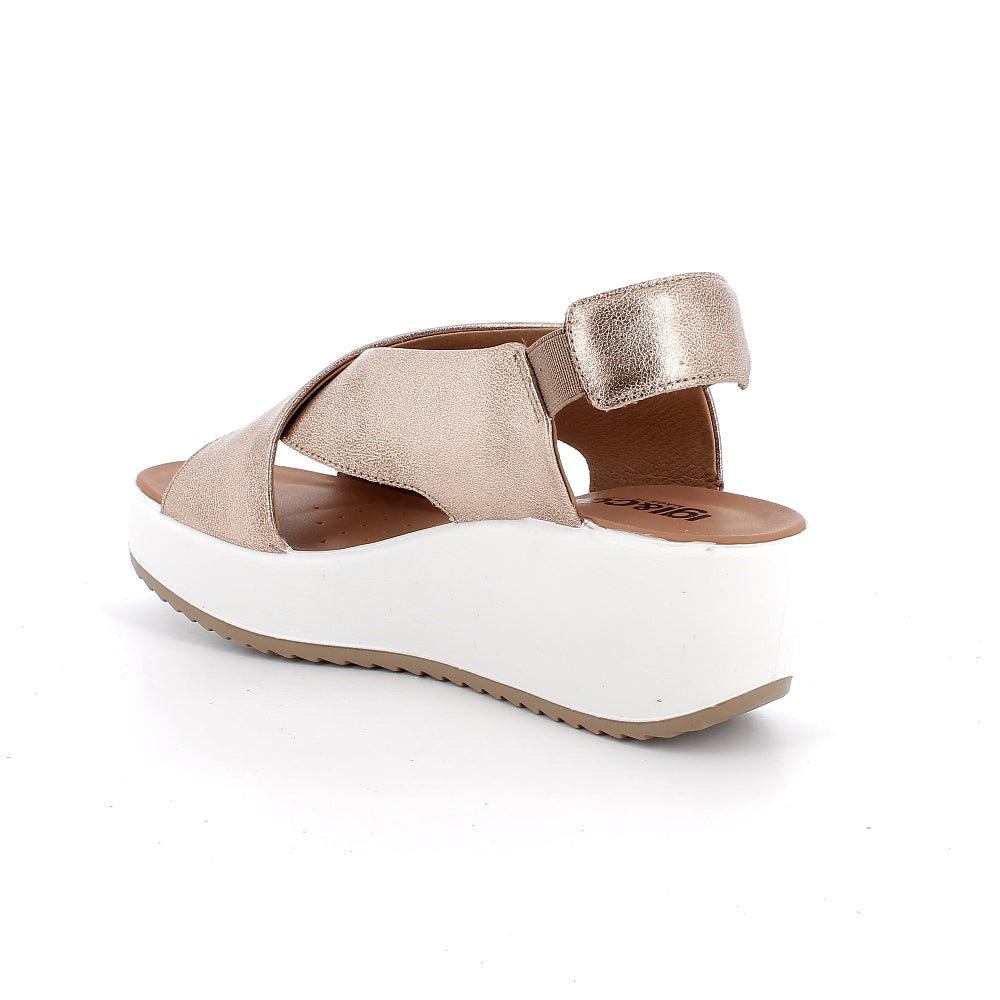 Sandal with white sole and rose gold straps on a white background