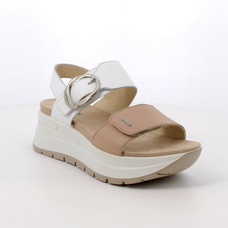 White and beige sandal with a platform sole on a white background