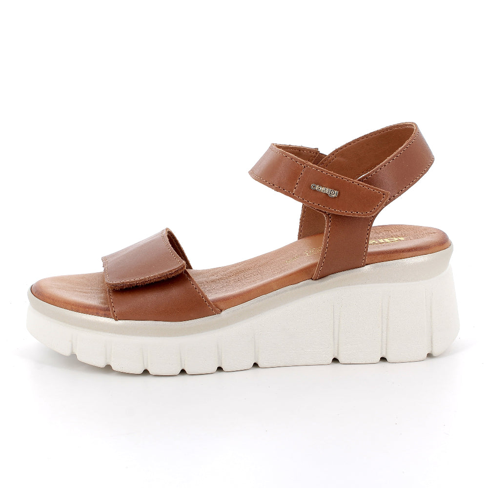 Brown sandal with white sole on a white background