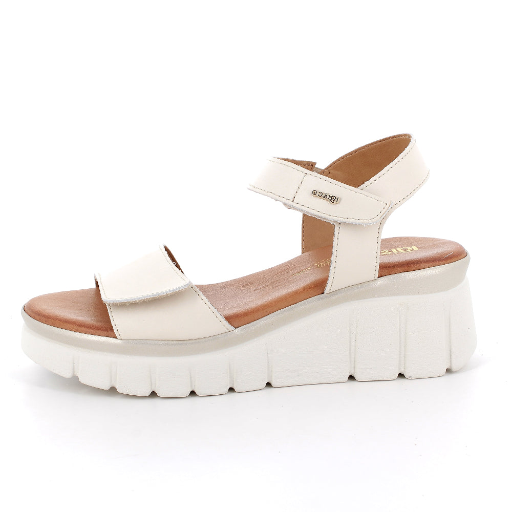 White sandal with brown sole on a white background