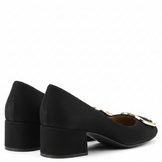black suede shoe with a gold buckle on a white background