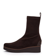 Load image into Gallery viewer, A dark brown suede ankle boot with a low wedge heel and a small pull loop at the back collar, shown from a side profile on a white background.
