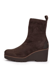 Load image into Gallery viewer, A dark brown suede ankle boot with a chunky wedge heel and a small pull tab at the back, shown from a side profile on a white background.
