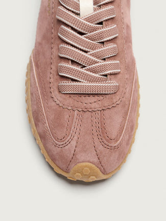 Pink sneaker with white sole on a light gray background
