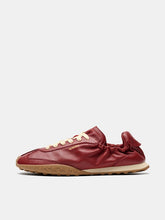 Load image into Gallery viewer, A single red leather sneaker with cream laces and a tan sole, shown in profile against a light gray background.
