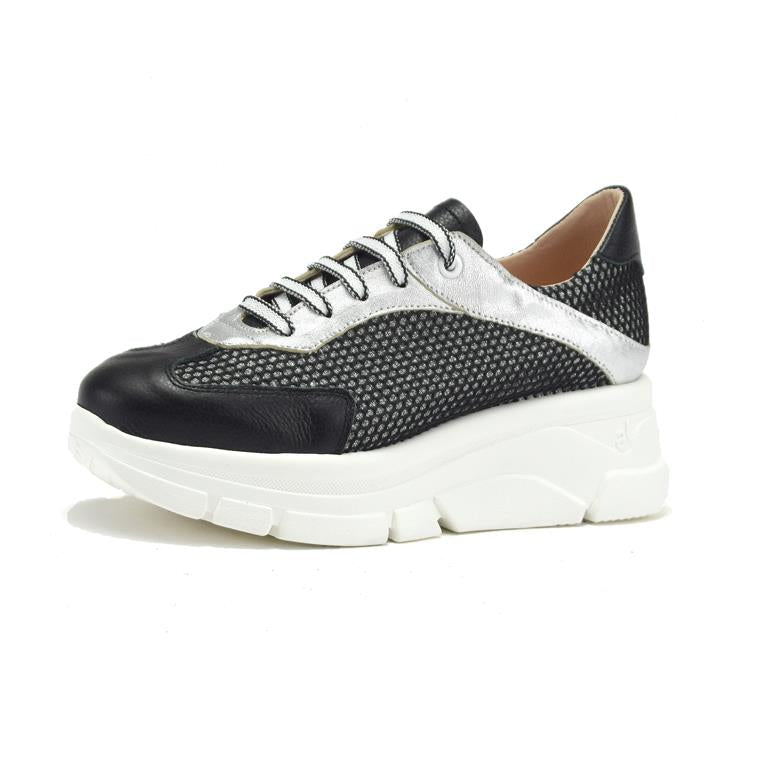 Black and white sneaker with a thick sole on a white background