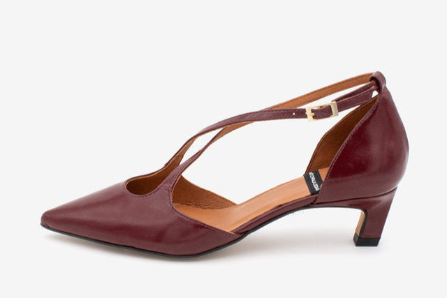 Maroon shoe with a thin strap on a white background