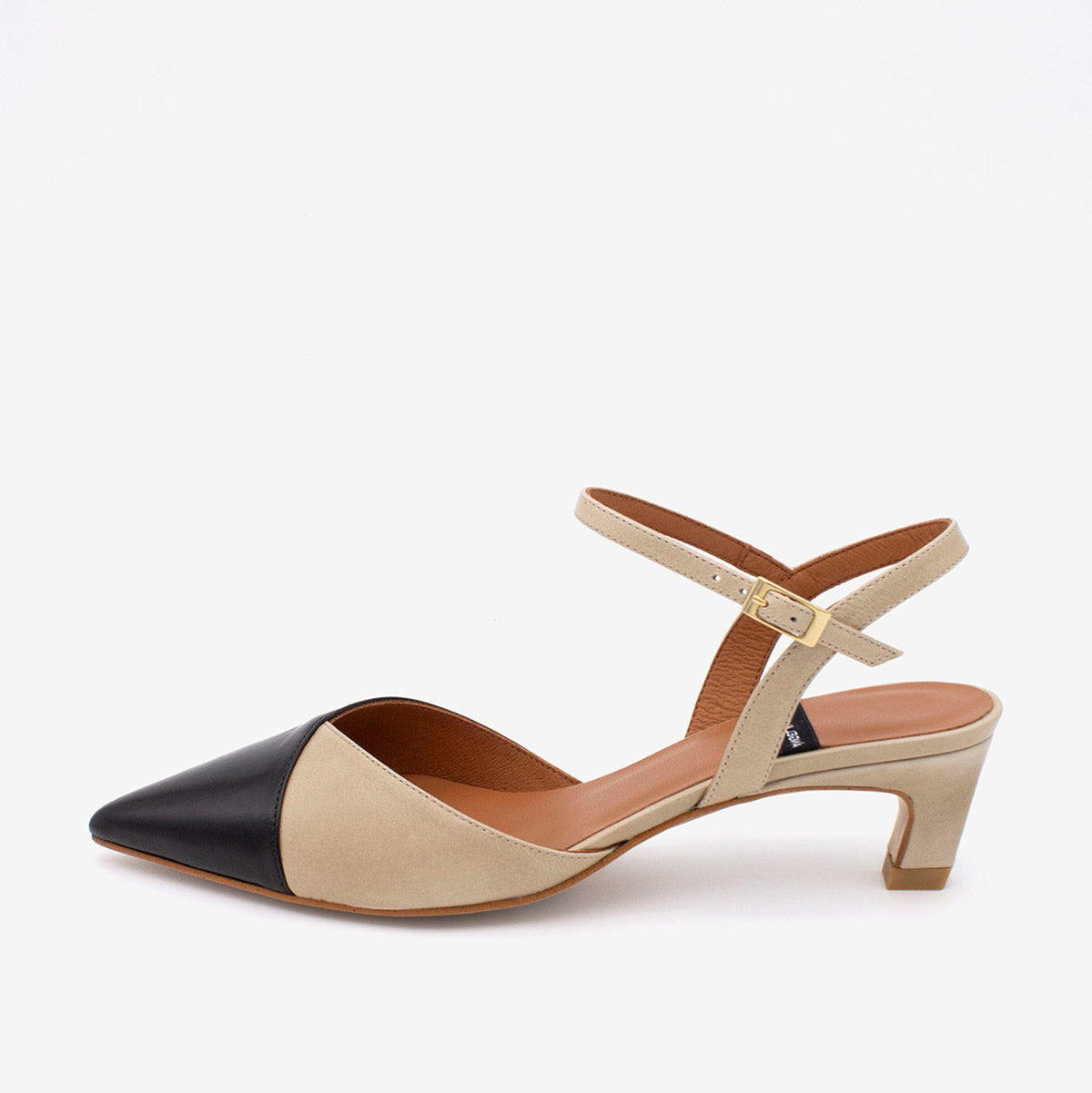 Two-tone sandal with beige and black design on a white background