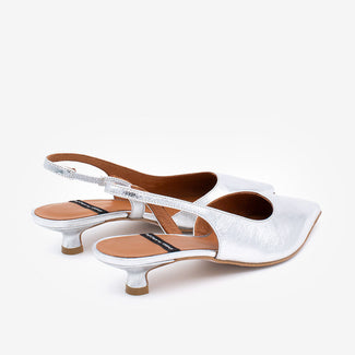 Silver pointed-toe slingback pump on a white background