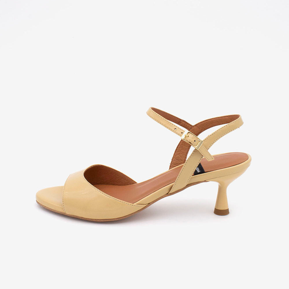 Beige sandal with a thin strap on a white background