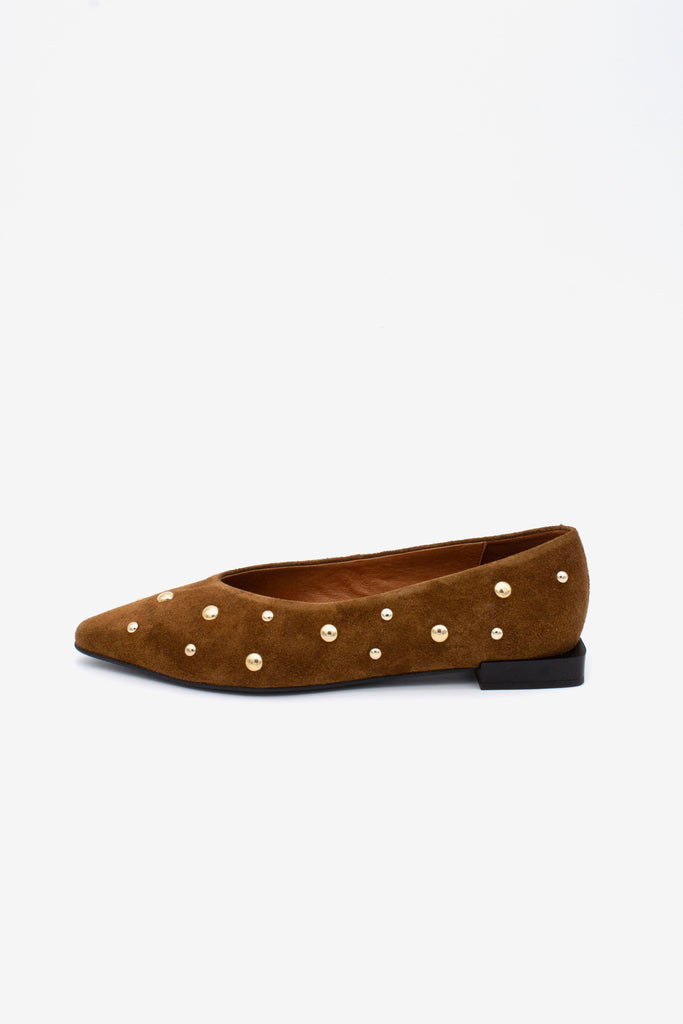 A single brown suede flat shoe with pointed toes and decorative gold-tone studs, shown in profile against a plain white background.