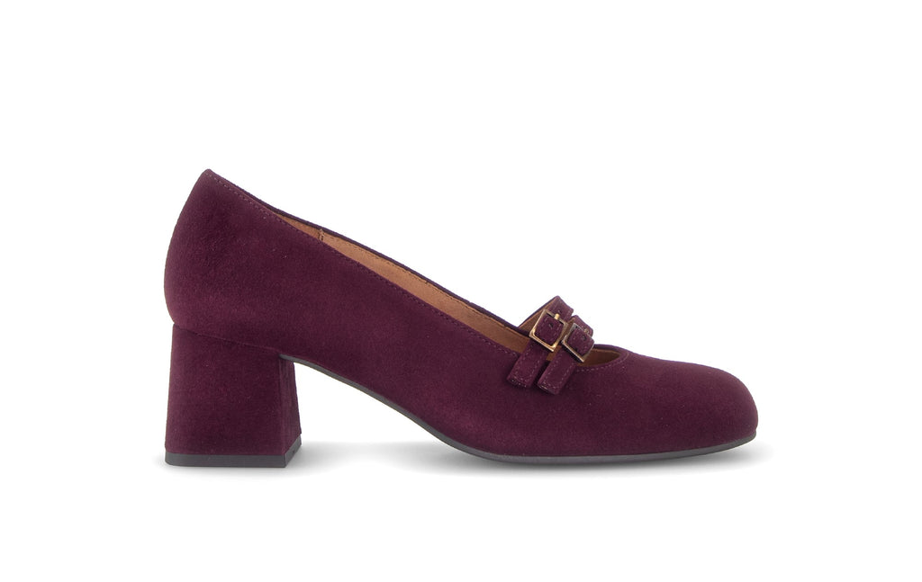 Purple shoe with a gold buckle on a white background