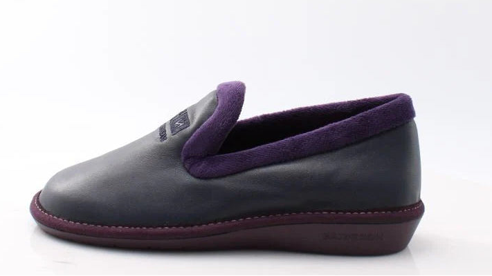 navy slipper with purple lining on a white background