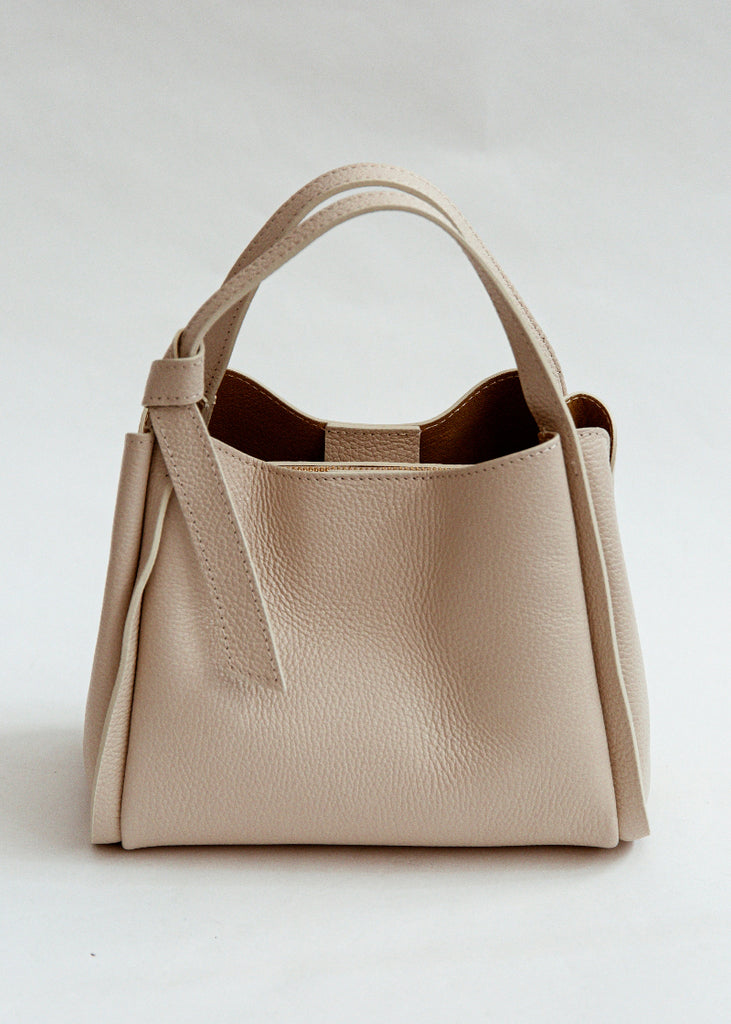 Beige handbag on a light gray background