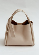 Load image into Gallery viewer, Beige handbag on a light gray background
