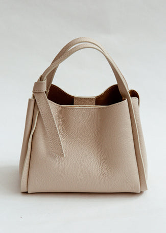 Beige handbag on a light gray background