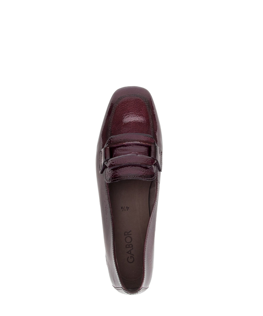 Maroon loafer shoe on a white background