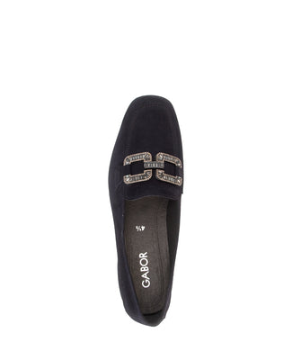 Navy blue loafer with a decorative buckle on a white background