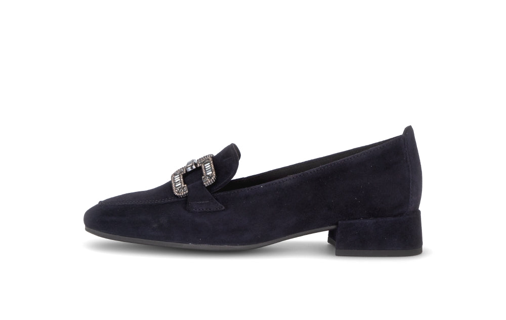 Navy blue loafer with a decorative buckle on a white background