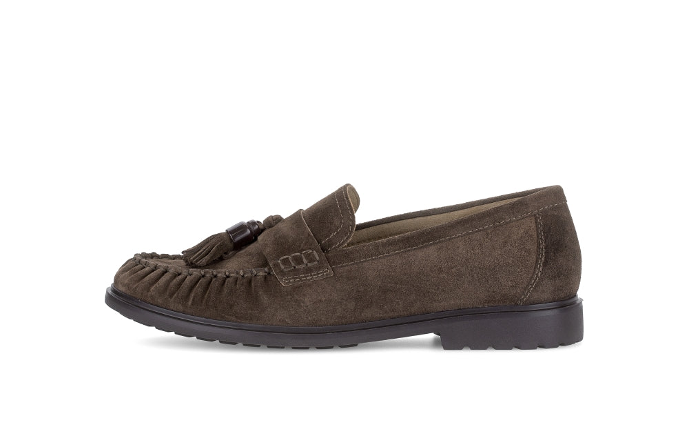 Brown suede loafer with tassel on a white background