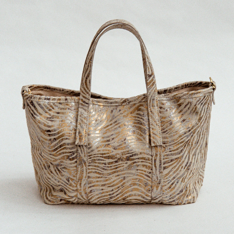 Metallic zebra-patterned handbag on a white background