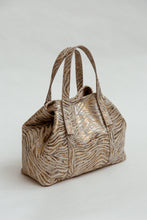 Load image into Gallery viewer, Gold and brown zebra-striped handbag on a light gray background
