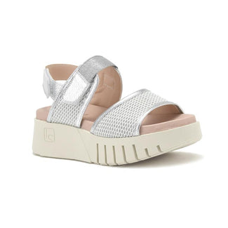 Silver sandal with pink sole on a white background